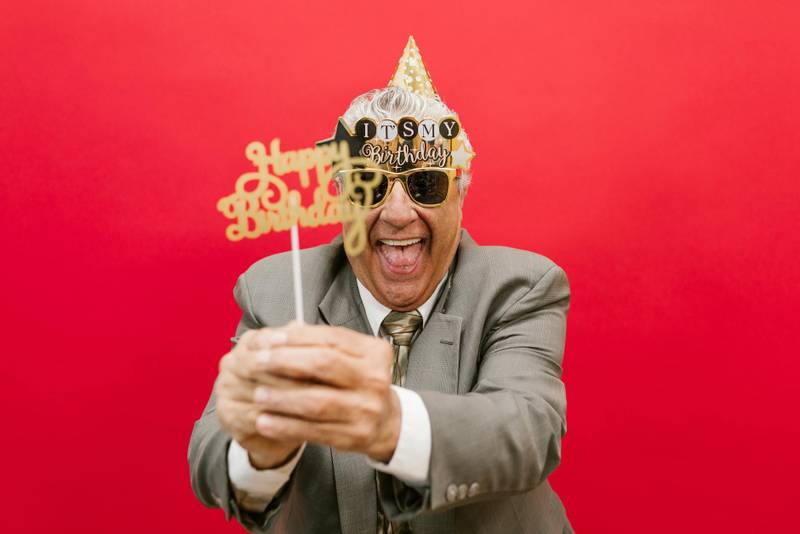 Fun photo booth props like hats, glasses, and signs brighten the Sydney event, with vibrant backdrops!